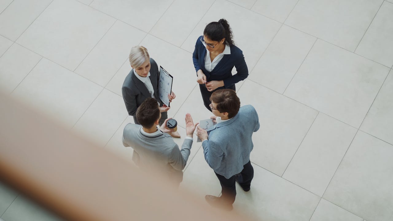 about-01 Overhead shot of diverse business team discussing a project indoors.